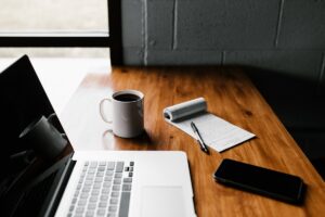 Writing desk with a laptop and coffee, representing the weekly M365 newsletter issue